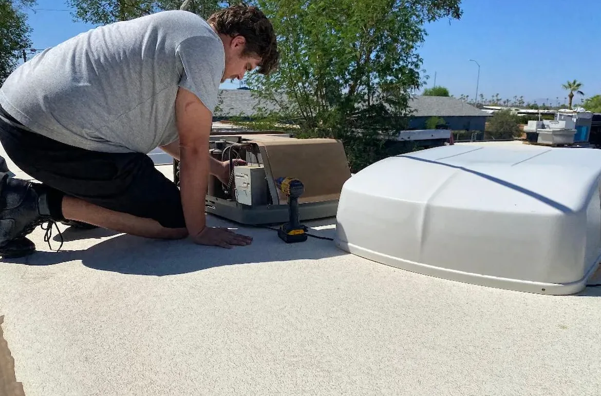 RV technician servicing a rooftop air conditioner on a recreational vehicle in Fellsmere, Florida